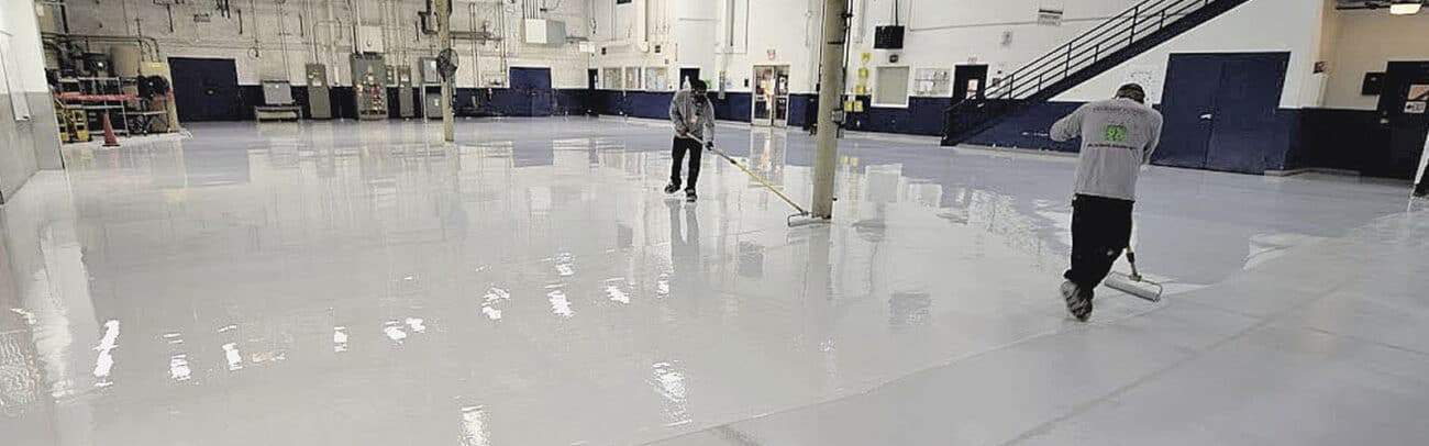 commercial concrete coatings being installed by applicators solid epoxy flooring